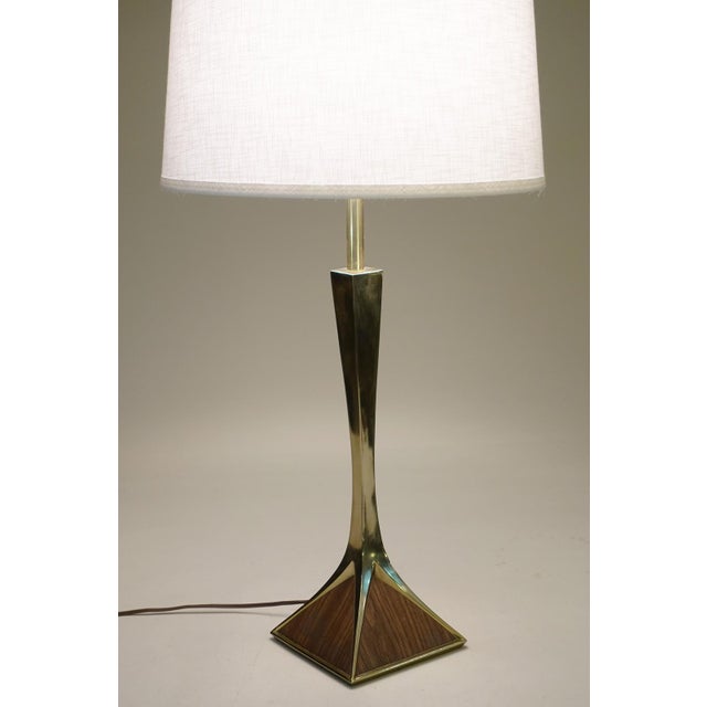 A minimal yet impressive Laurel Mid Century Modern polished Brass & Walnut veneer "Pyramid" table lamp designed and...