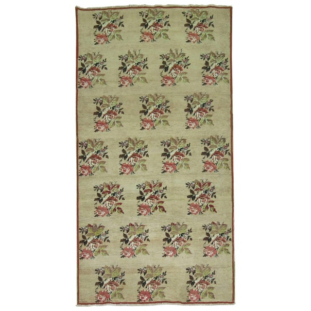Vintage Turkish rug with an all-over floral design on a came colored ground. 3'10'' x 7'2''