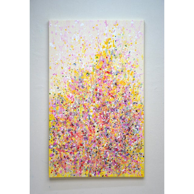 This piece bursts with joyful energy, pouring bright yellows, pinks, and purples onto the canvas like a celebration of...