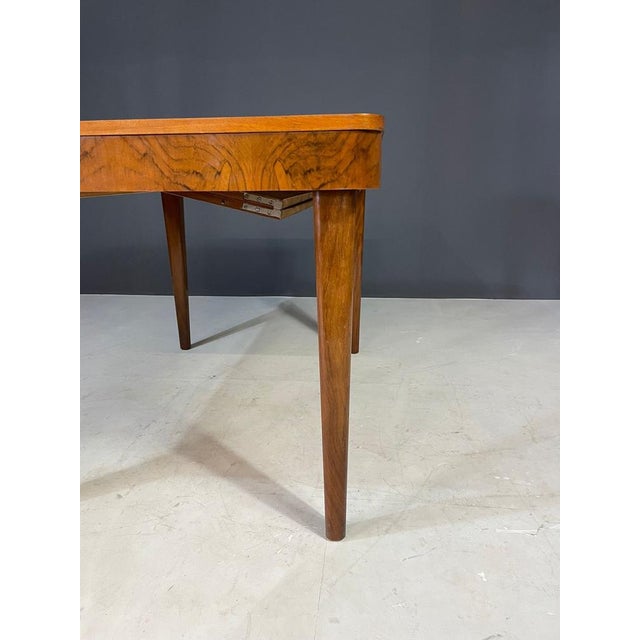 Extendable dining table from the 1950s, designed by Jindřich Halabala and made in former Czechoslovakia. Crafted in walnut...