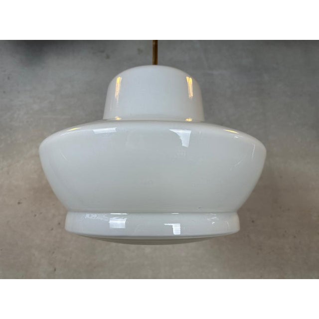 Art deco hanging lamp with somewhat exceptional lampshade in terms of design and finish. Opaline in milk color and frosted...