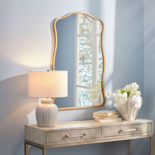 Step away from the square and infuse your home with character using this curvy wall mirror. Its vertical orientation and...