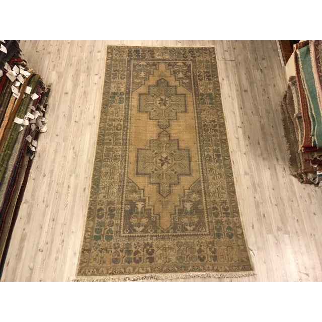 This is a vintage Turkish Oushak rug from the 1960s. The piece was hand-knotted.