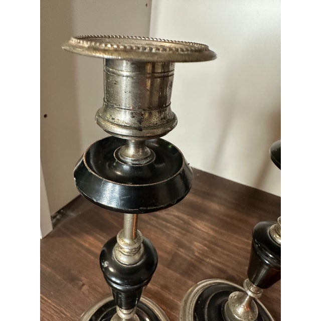 Gorgeous pair of French ebony and metal candlestick holders. Beautiful vintage patina