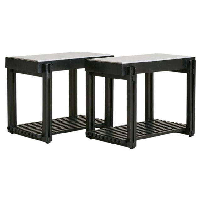 A French end table from the 1970s, combining architectural woodwork with a rectangular white marble top veined in soft...