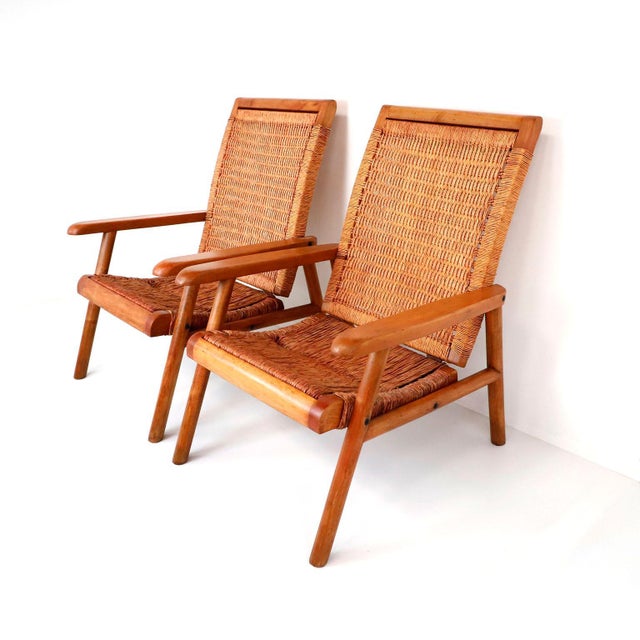 Pair of Mexican Mid-Century Modern woven lounge chairs made in the 1950s. Featuring simple but elegant modern frames and a...