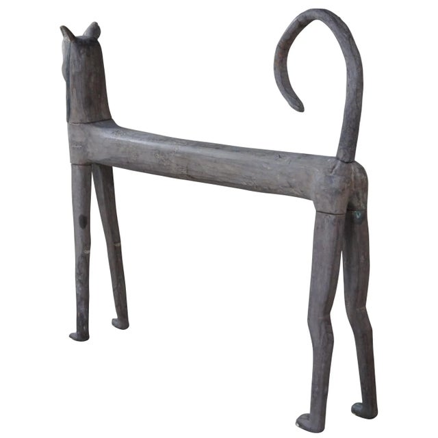 20th Century hand carved folk art wooden cat form sculpture or statue. Features a knockdown design with elegant form....
