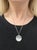 An exquisite Renee Lewis necklace showcasing a shaker pendant with faceted rock crystal compartment holding a collection...