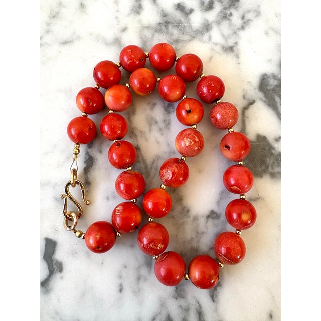 Lovely coral beaded necklace with gold tone, spacers, and clasp designed by Matthew Izzo