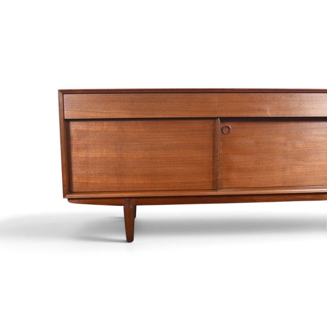 This low credenza was designed by John Herbert and produced by A Younger Ltd in England during the 1960s. The teak and...