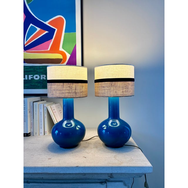 Pair of tall-necked, round vases converted into lamps. In dark turquoise porcelain. In excellent condition – no chips or...