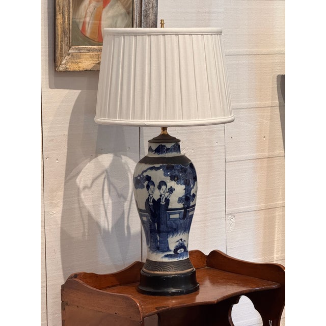 A Chinese blue and white porcelain vase mounted as a lamp, painted with two female figures in a garden setting beneath a...