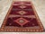 A vintage Turkish Anatolian tribal room size carpet, in long and narrow format, handmade during the mid-20th century....