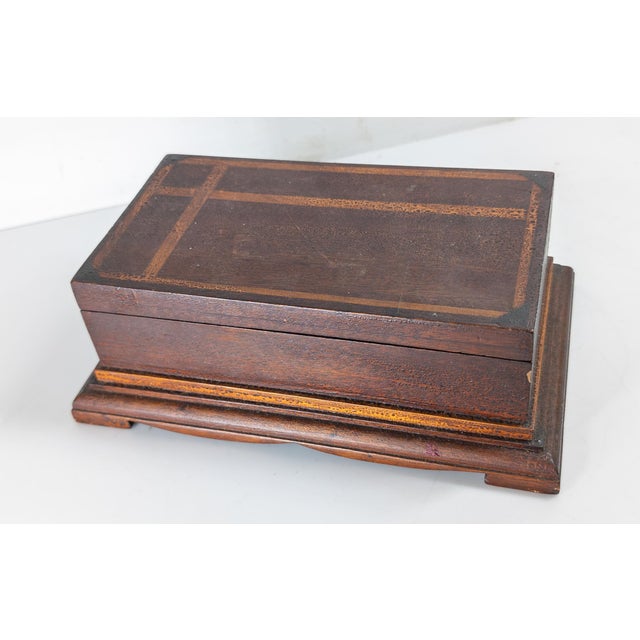 We are selling this great Folk Art inlaid wood dresser or jewelry box. This box has simple inlaid decoration on the lid...