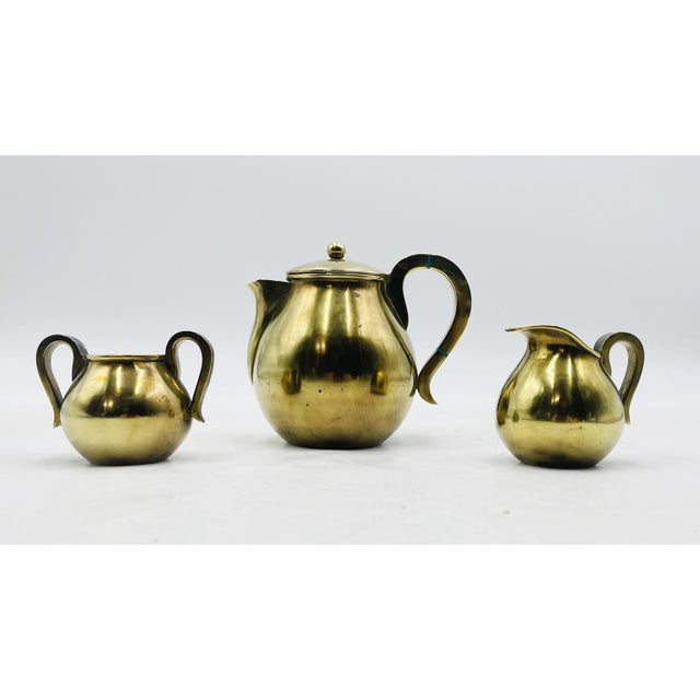 An exceptional 1950s Mexican Modern three-piece tea service handcrafted by the renowned Los Castillo workshop in Taxco,...