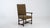 A 19th century throne chair designed in the Louis XIII style, featuring a structured wooden frame with a high back. The...