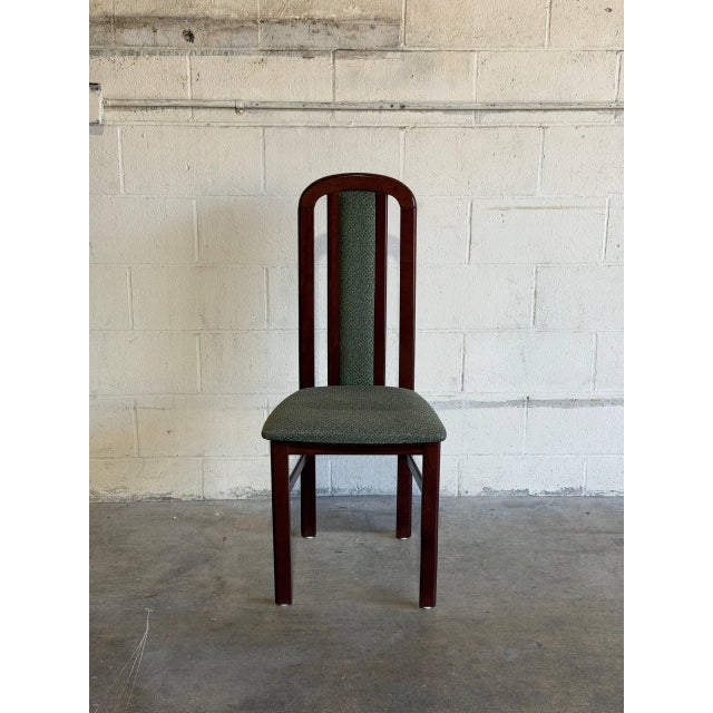 This single high-back dining chair features a sleek vertical profile and supportive frame. The tall back incorporates an...