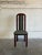 This single high-back dining chair features a sleek vertical profile and supportive frame. The tall back incorporates an...