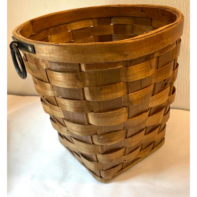 Nice vintage wicker slat planter basket with iron rings on each side.
