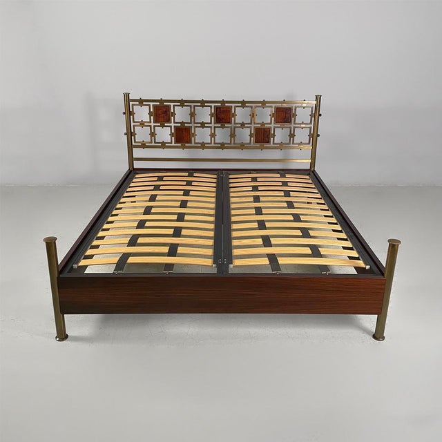 Italian mid-century bed Osvaldo Borsani & Arnaldo Pomodoro, 1950s Double bed featuring a dark wood frame and gilded brass...