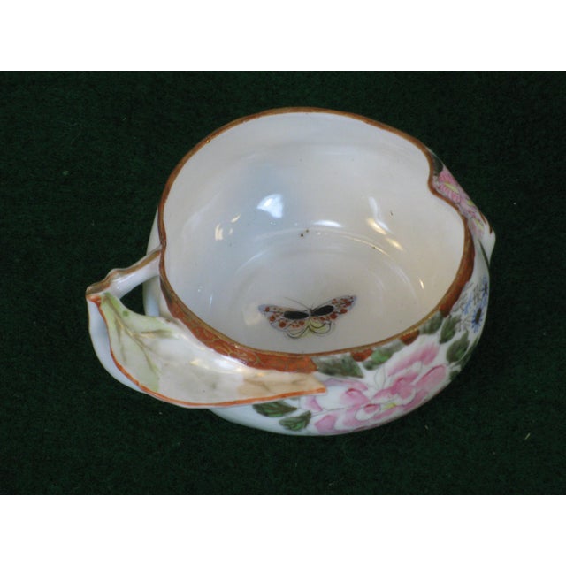 Antique Japanese teacup set featuring a hand-painted design in multi-color. Made of porcelain and originating from Japan...