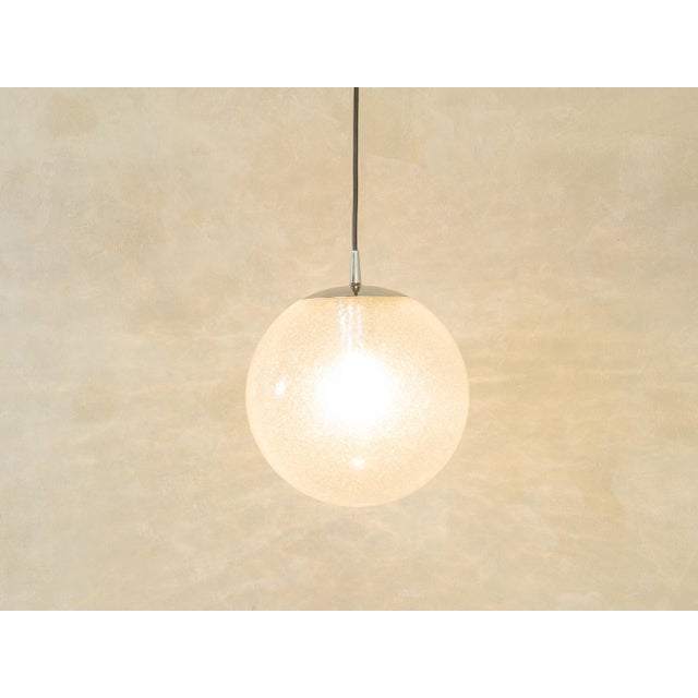 Classic Bauhaus-era spherical ceiling lamp by Peill & Putzler from the 1950s. The lampshade is made of frosted opal glass...