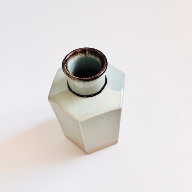 A vintage pottery vase designed by Niels Refsgaard for Dansk. Hexagonal shape in the "Brown Mist" pattern. Pale gray...