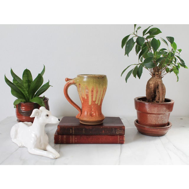 Studio art drip glaze pottery coffee mug. Signed on bottom "Ash" dated 2009.