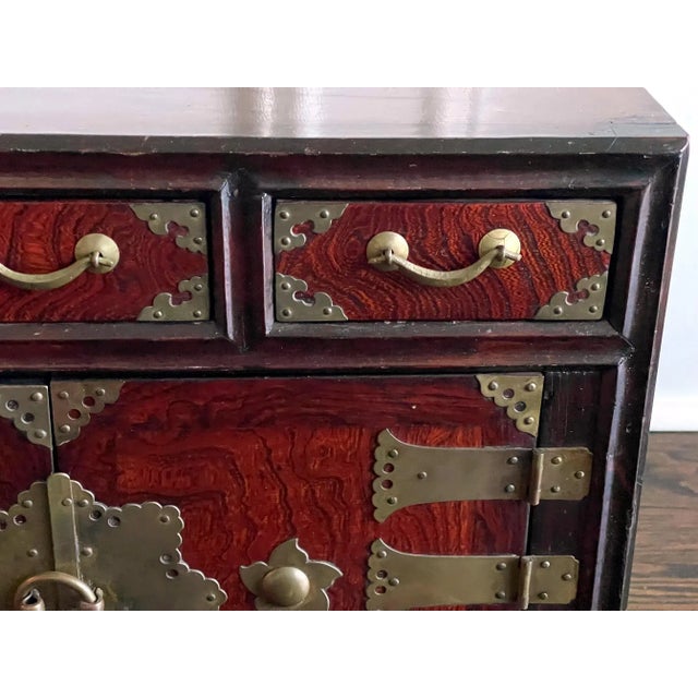 A small Korean mixed wood cabinet dated to Joseon Dynasty circa 19th century. The cabinet was used to keep valuables such...