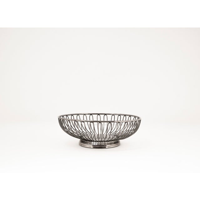 This lightweight, timeless fruit basket crafted from bent metal wire in the Mid Century Modern style combines functional...