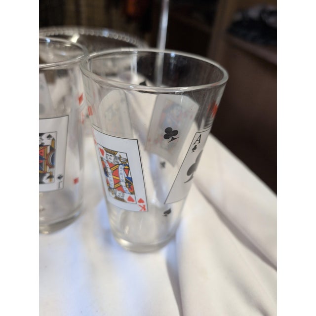 Set of three glass tumblers featuring a unique playing card design. • Decorated with vibrant playing card motifs • Perfect...