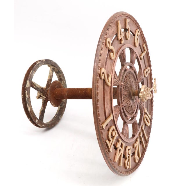 Early 20th century brass elevator dial with foliate motifs, a beaded border, and a fleur de lis indicator arrow. The back...