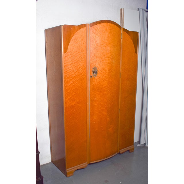 This refined English Art Deco wardrobe, slightly smaller in scale than standard pieces, exemplifies the elegance and...