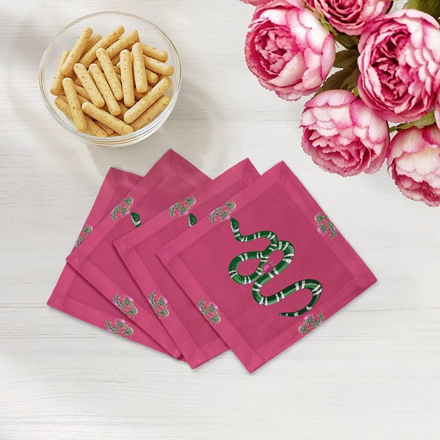 Thistle And Snake Cocktail Napkins intertwine thistle floral patterns with bold serpent motifs, creating a striking mix of...