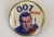 Classic 1960's metal 'lapel' pin with 'James Bond' Agent 007 colour graphics. Diameter: 7/8"