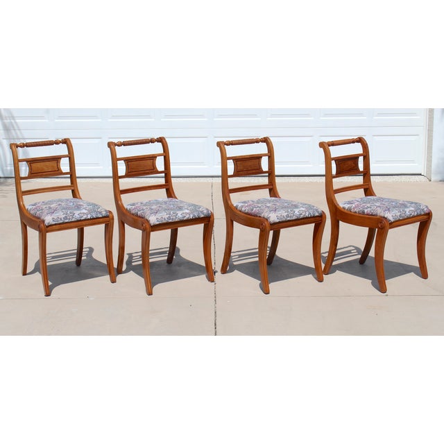 Elegant set of four vintage American-made dining chairs crafted in richly figured walnut and inspired by the refined...