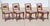 Elegant set of four vintage American-made dining chairs crafted in richly figured walnut and inspired by the refined...