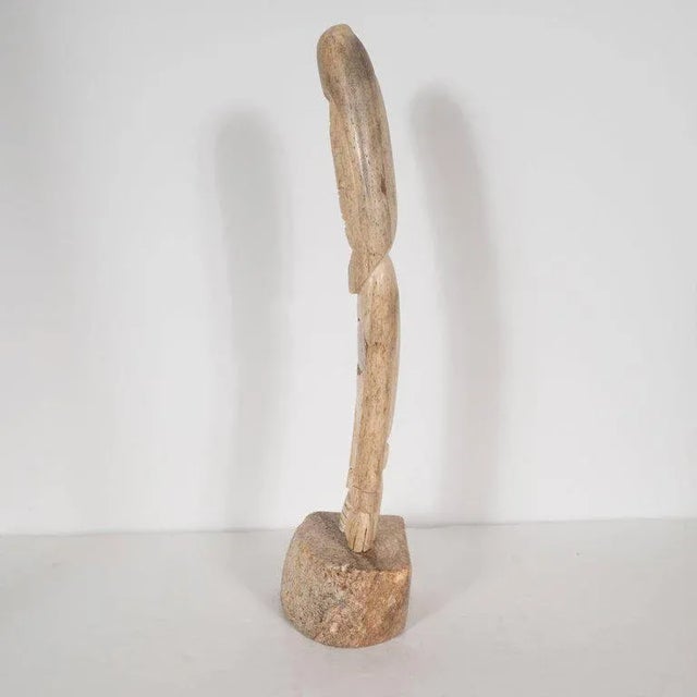 This handcrafted birchwood totem offers a stylized depiction of an inuit man. The facial features, consistent with native...