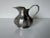 A charming vintage Italian pewter small pitcher featuring a scalloped rim and bulbous body with elegant curves. The handle...