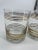 Mid-Century lowball glasses set featuring gold rings at the top and bottom. Set of four.