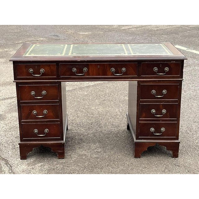 Pedestal Desk In Flame Veneer Mahogany with Green Leather Top. Splits in 3 pieces for easier transportation. Signs of wear...