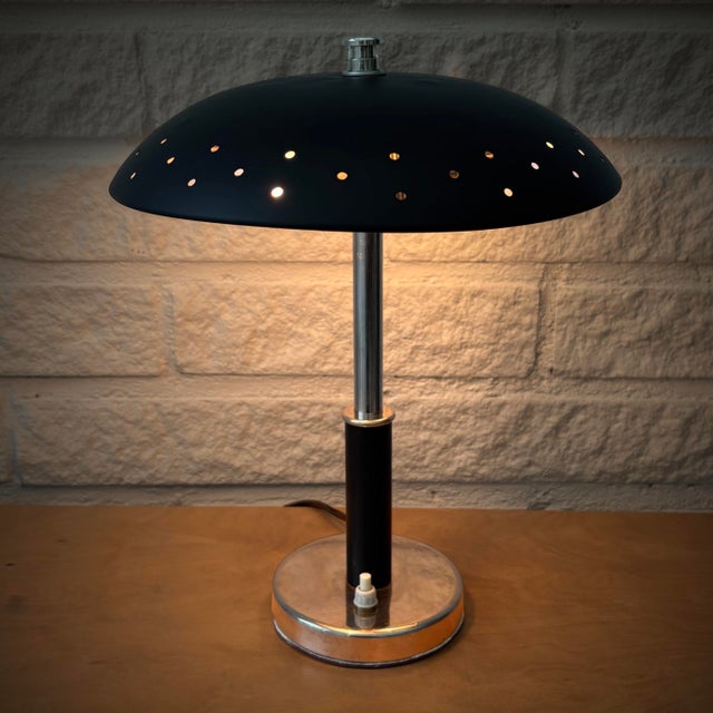 A Swedish modernist table lamp manufactured during the 1940s by an unidentified Swedish manufacturer. The lamp features a...