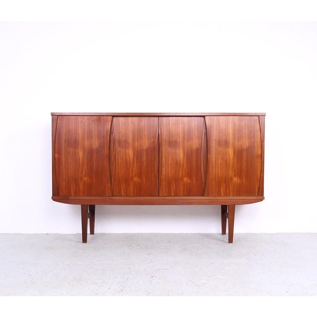 Vintage teak highboard from Denmark, 1960s Danish highboard crafted in teak veneer with four sliding doors and refined...