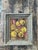 This evocative still life, signed by artist Kenneth Williams, captures a cluster of sun-drenched fruit with the tactile...