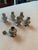 Six small silver salt and pepper shakers have their own velvet pouch.