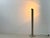 A distinctive designer lamp with a ribbed, architectural body and striking metal bracket. The upper lamp head tilts,...