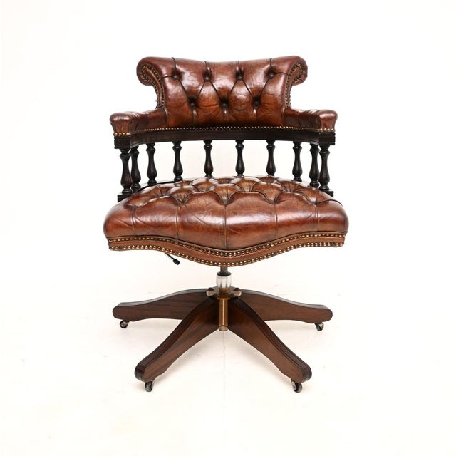 A wonderful antique leather swivel captains desk chair. This was made in England, it dates from around the 1950’s. It is...