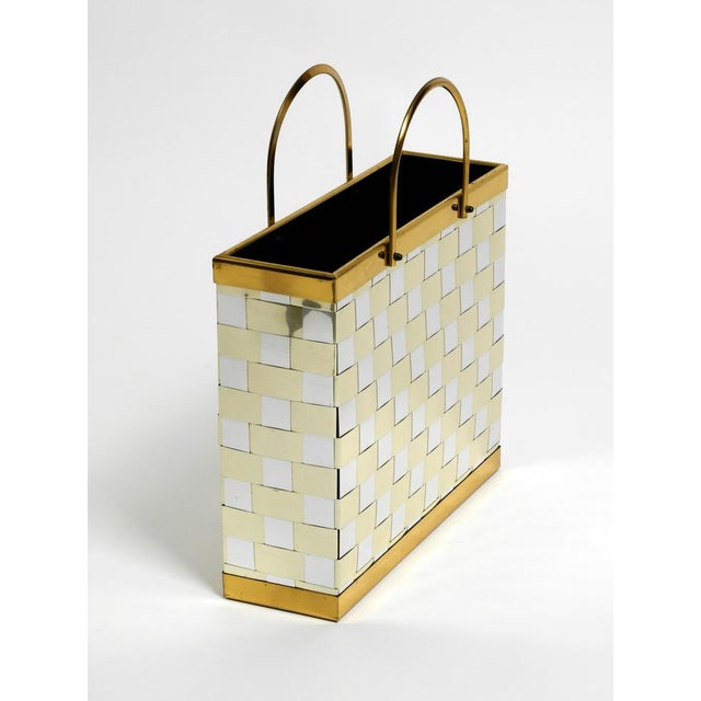 Extraordinary rare 1980's brass magazine rack in Hollywood Regency design. Made entirely of brass. Braided with brass...