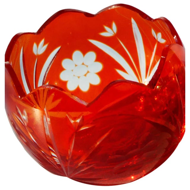 Vintage set of two ornate cut-glass candleholders with intricate motifs and details.