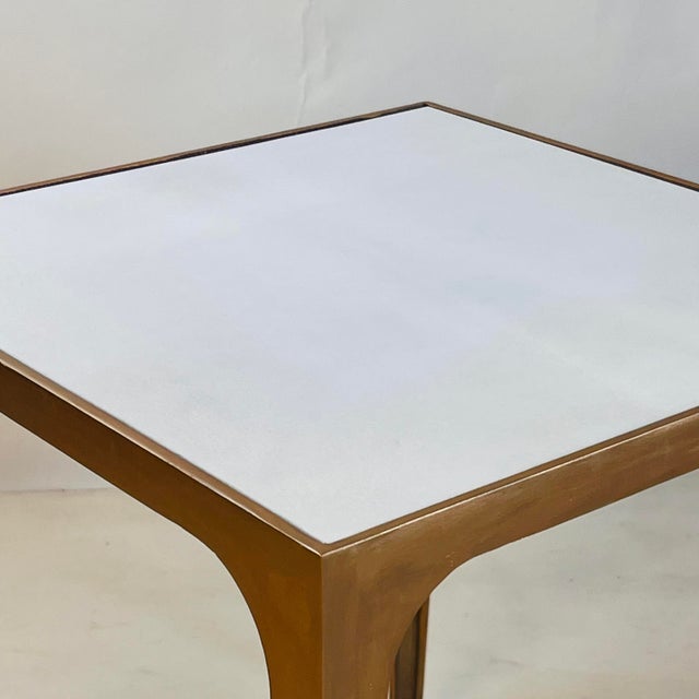 This compact side table pairs a hand-finished gilt metal frame with a luxurious goatskin-clad top, creating a refined...